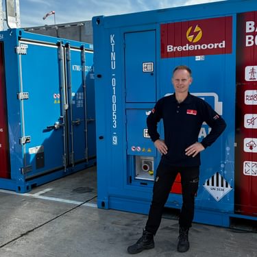 Trainer Patrick in front of batteries